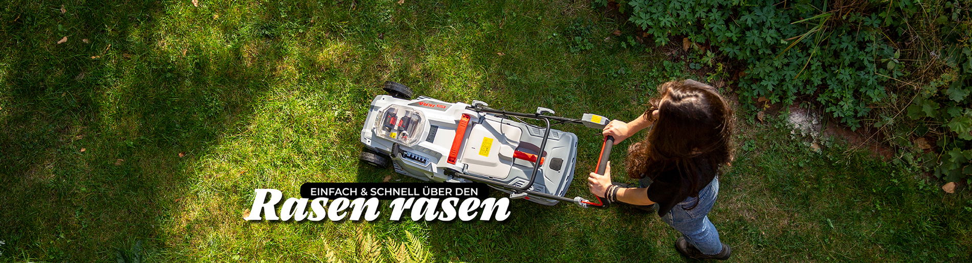 Frau aus der Vogelperspektive mäht einen rasen